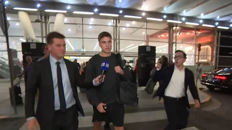 Swans player swarmed at airport